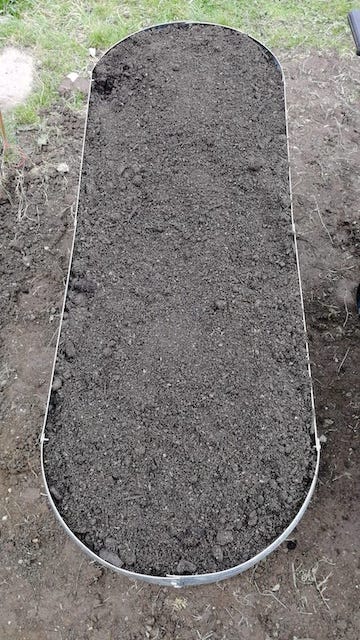 A raised bed full of soil